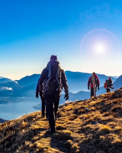 Group of travellers hiking along a mountain ridge on an extended single trip.