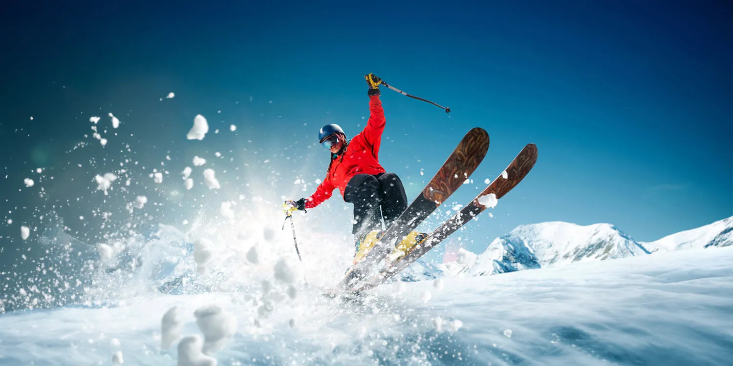 A skier carving through deep snow on a mountain slope